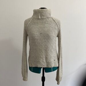 Cream colored, raglan sleeve, knit turtle neck sweater with bell sleeves